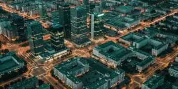 Aerial view of a city at dusk, showing interconnected financial, educational, and residential districts with green glowing lines representing data flow for informed decision-making.